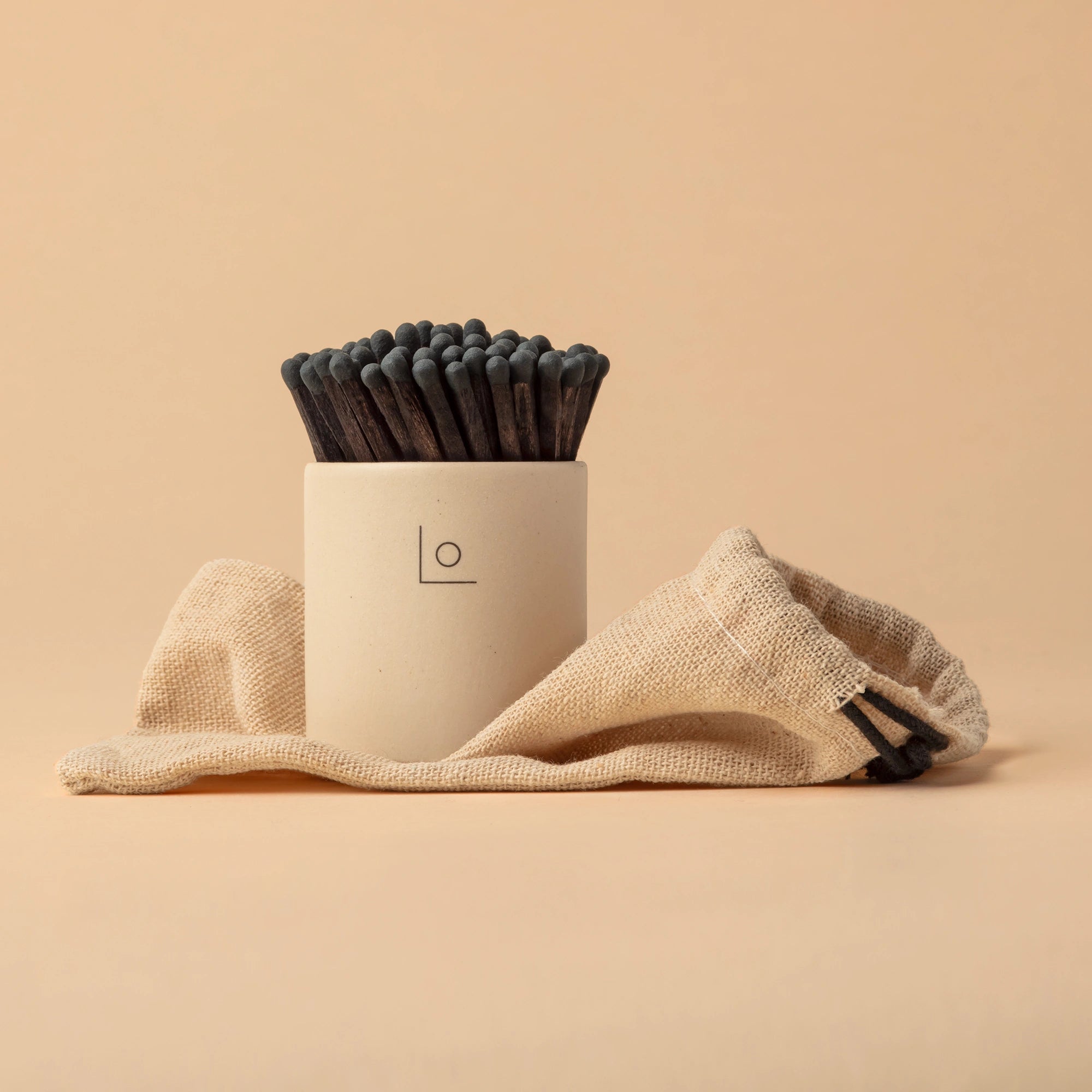 Stoneware match pot on linen bag black matches