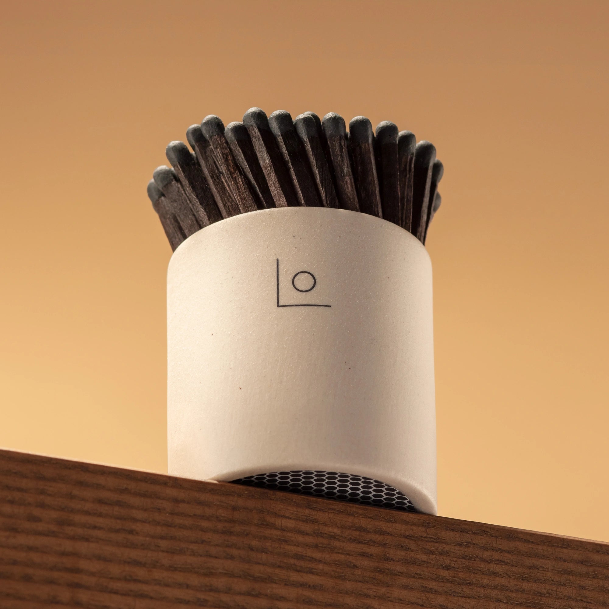 Stoneware match pot showing underside which is strikeable with black matches